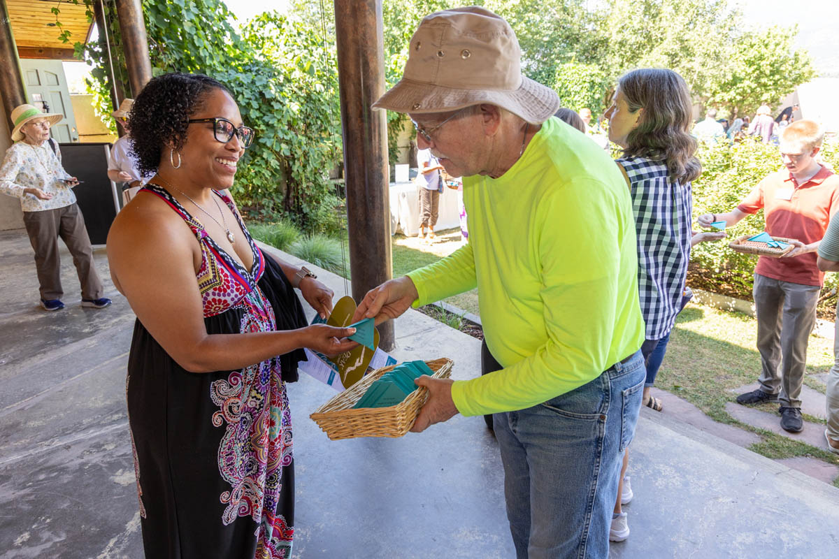 Attendees visiting outside on a sunny afternoon
